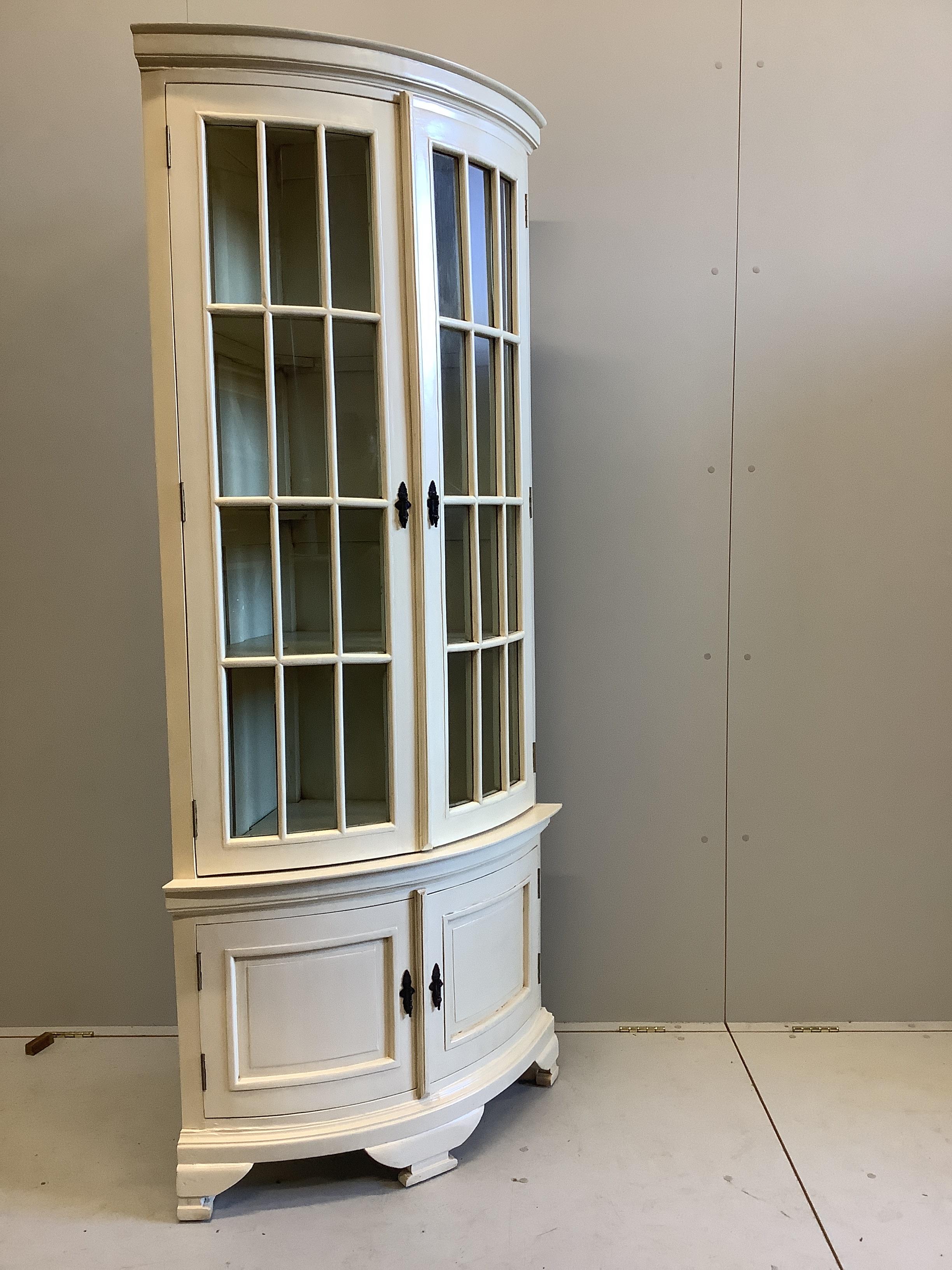 A reproduction George III style painted bow front standing corner cabinet, width 96cm, depth 58cm, height 200cm